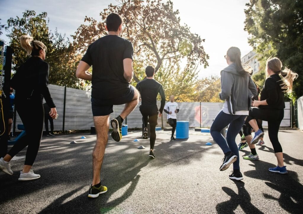 man in black t-shirt and black shorts running on road during daytime